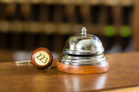 Reception - Hotel bell and key lying on the desk